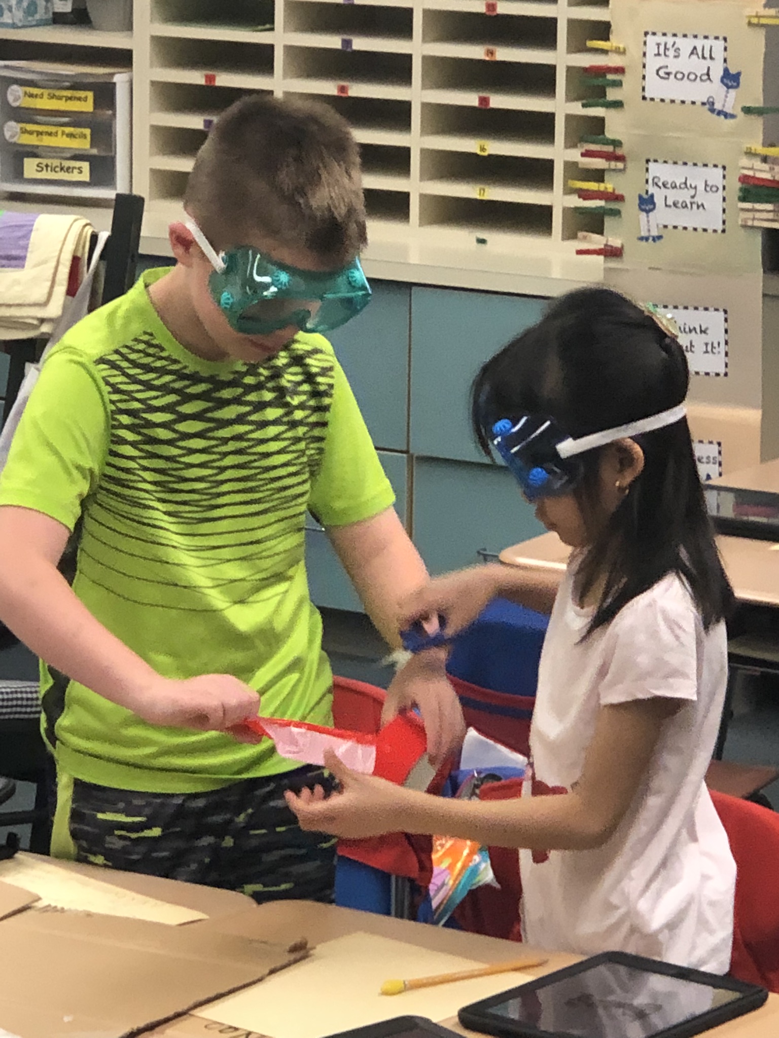 A young male and female student working together on a STEM project.